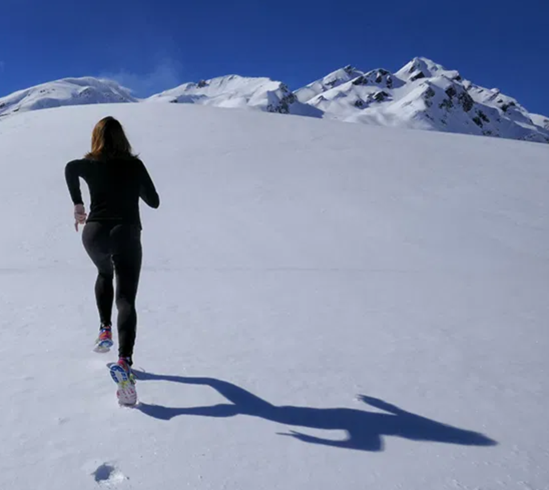 women running across snow - ski trip preparation